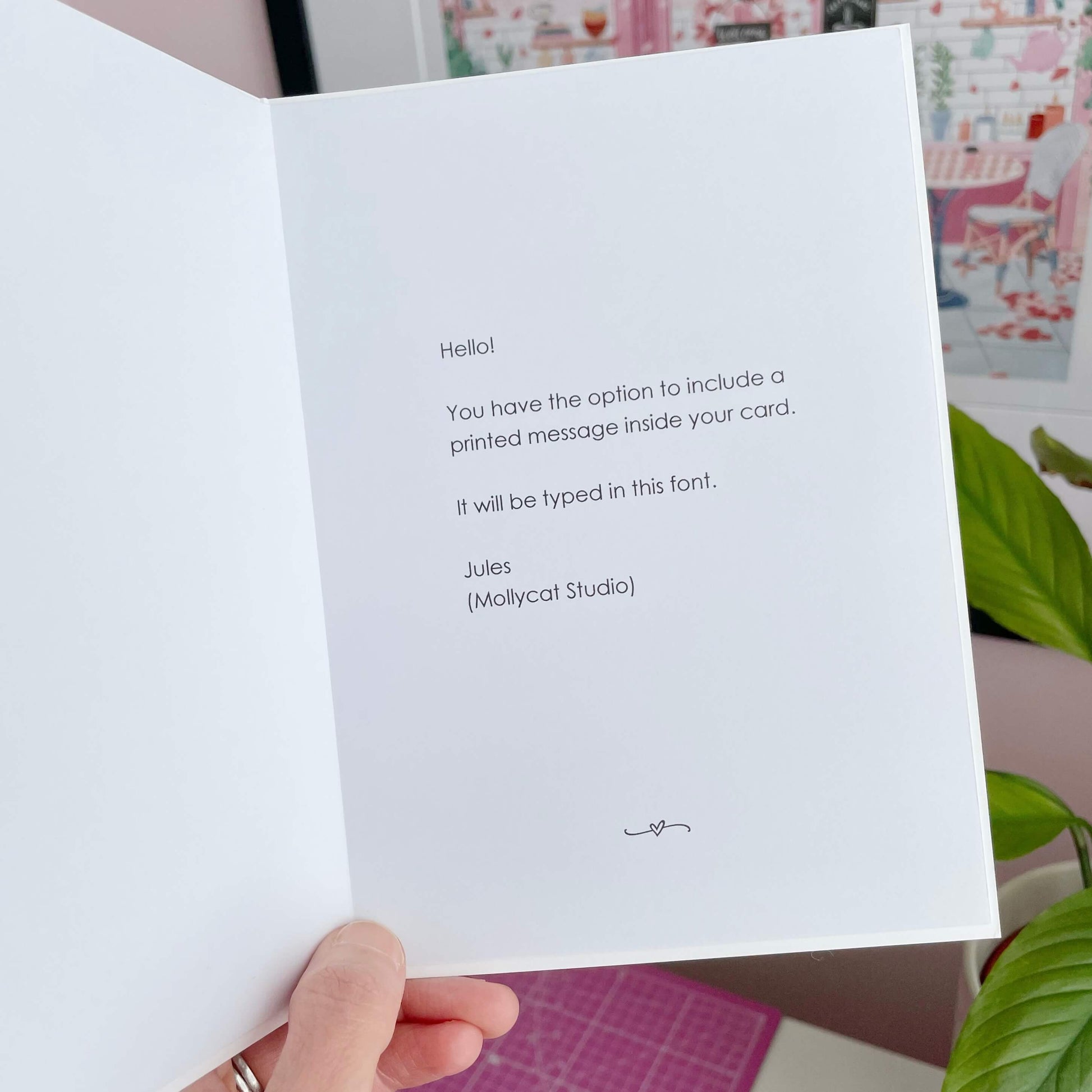 White card with printed text held by a hand.