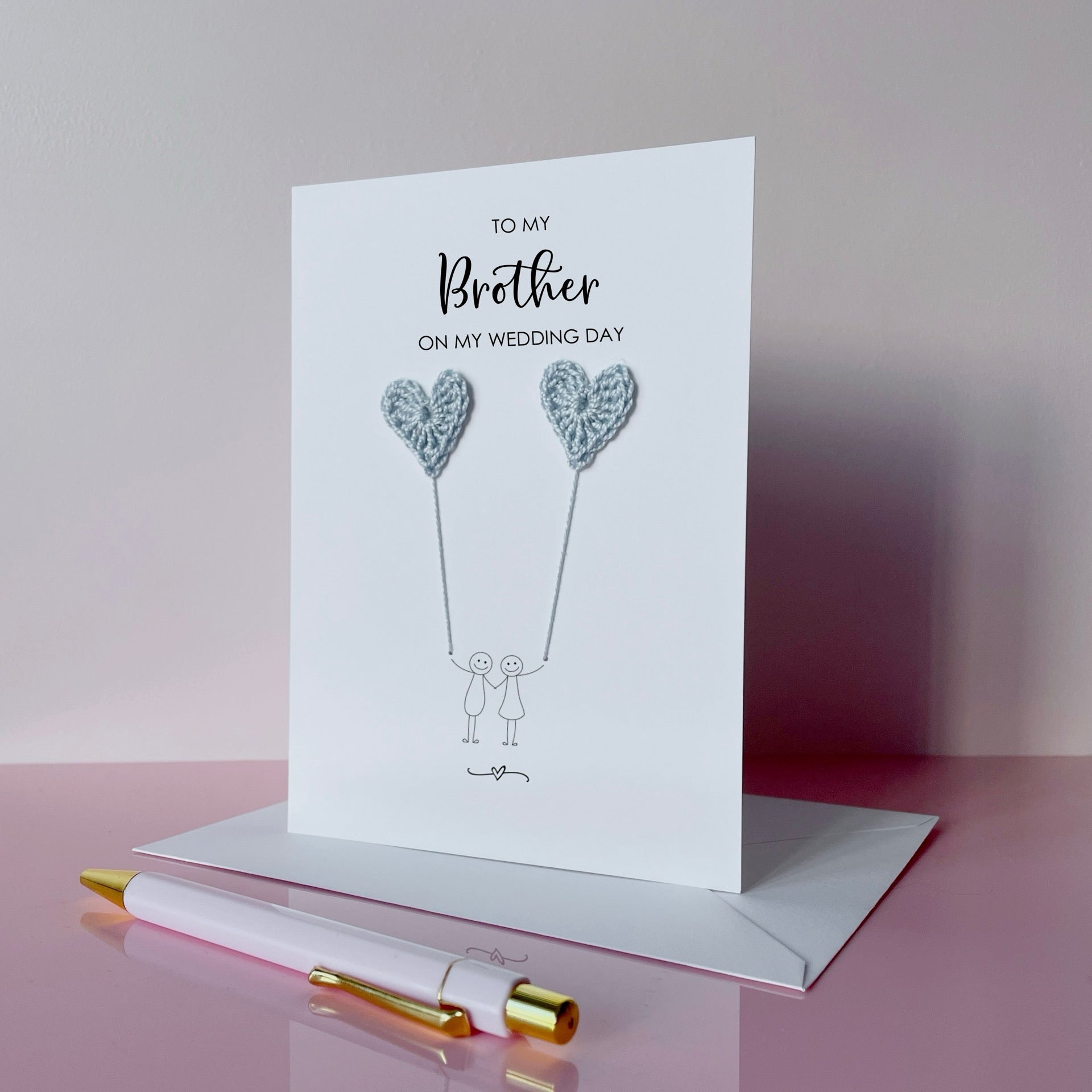 Greeting card with pale blue crochet heart balloons. The text at the top of the card reads 'To my Brother on my wedding day' 