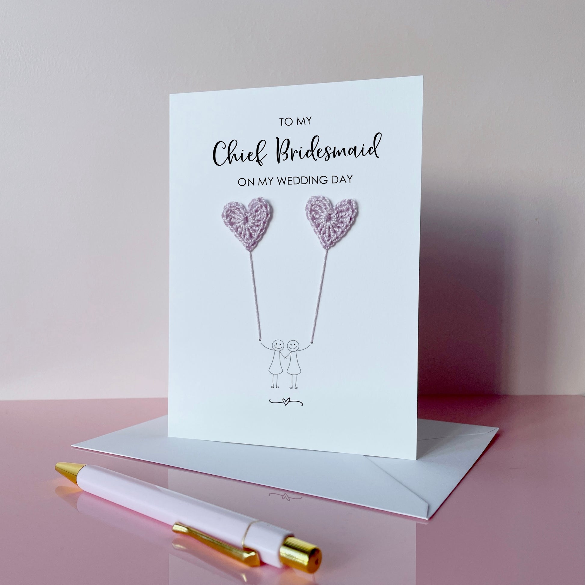 Greeting card with lilac crochet heart balloons and text on a pink surface. The text at the top of the cad reads 'To my Chief Bridesmaid on my wedding day' 