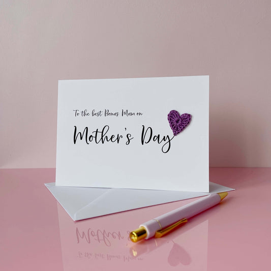 'To the best Bonus Mum on Mother's Day' is printed on this card, finished wth a cutr purple crochet heart. 