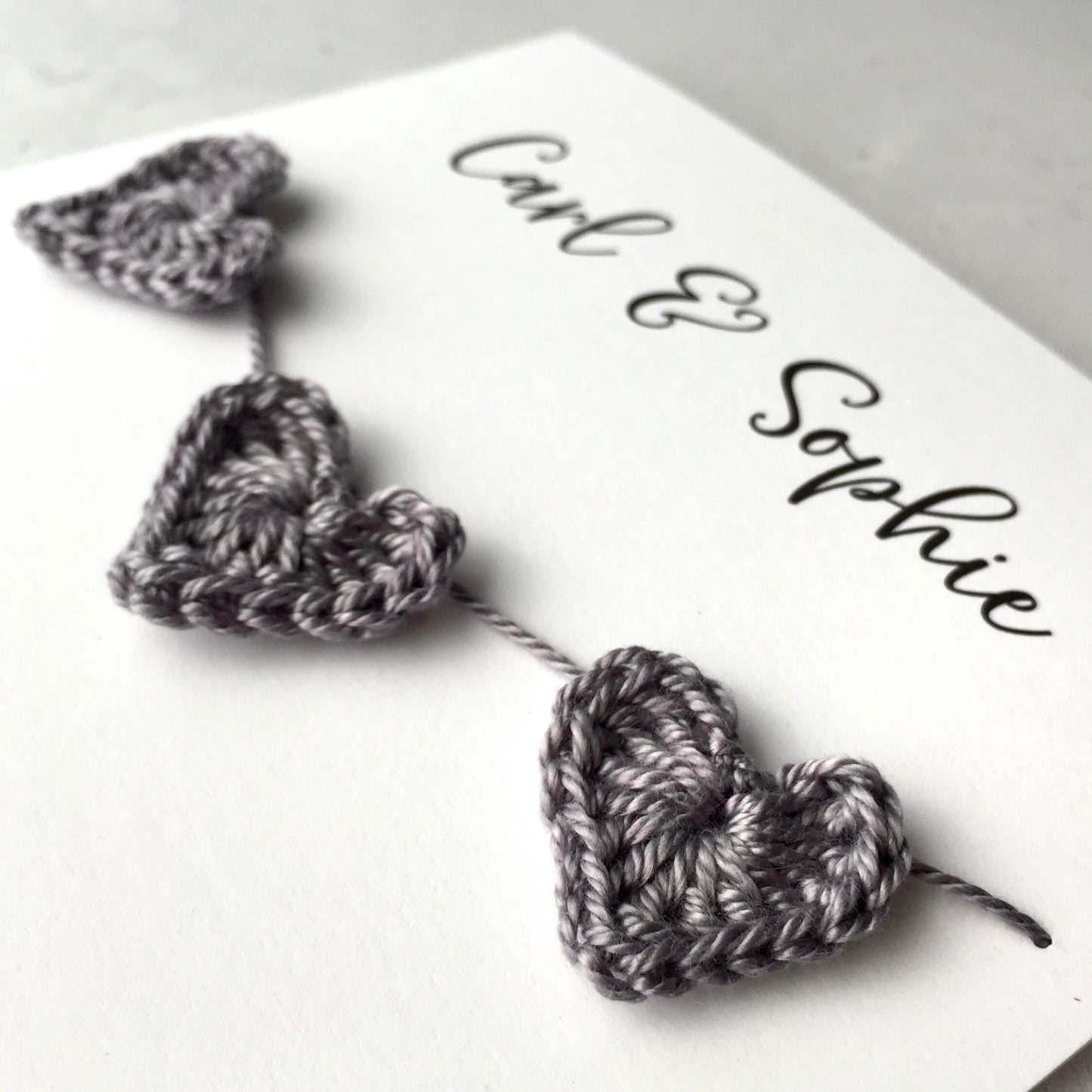 Engagement card finished with 3 crochet hearts